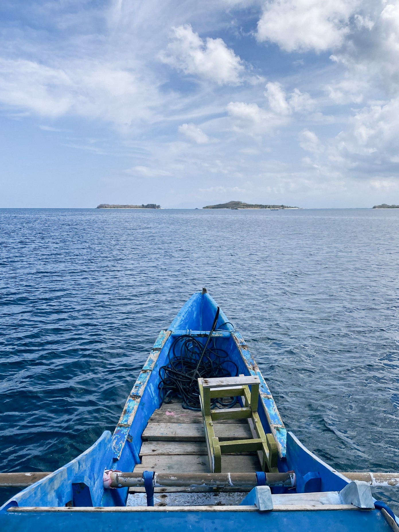 Traditional wooden boat heading to the Secret Gilis, Lombok, Indonesia.